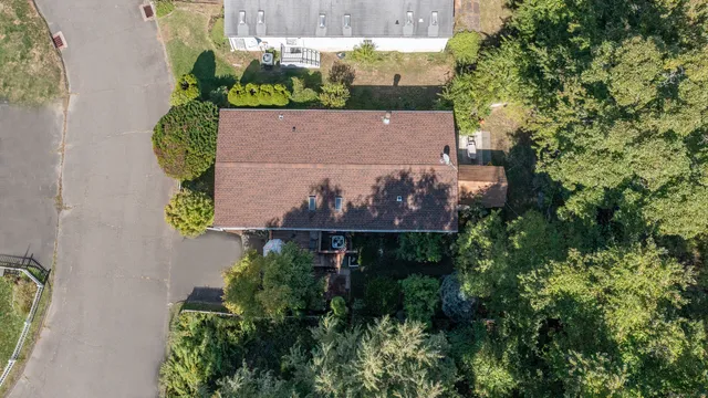an aerial view of a house with a yard