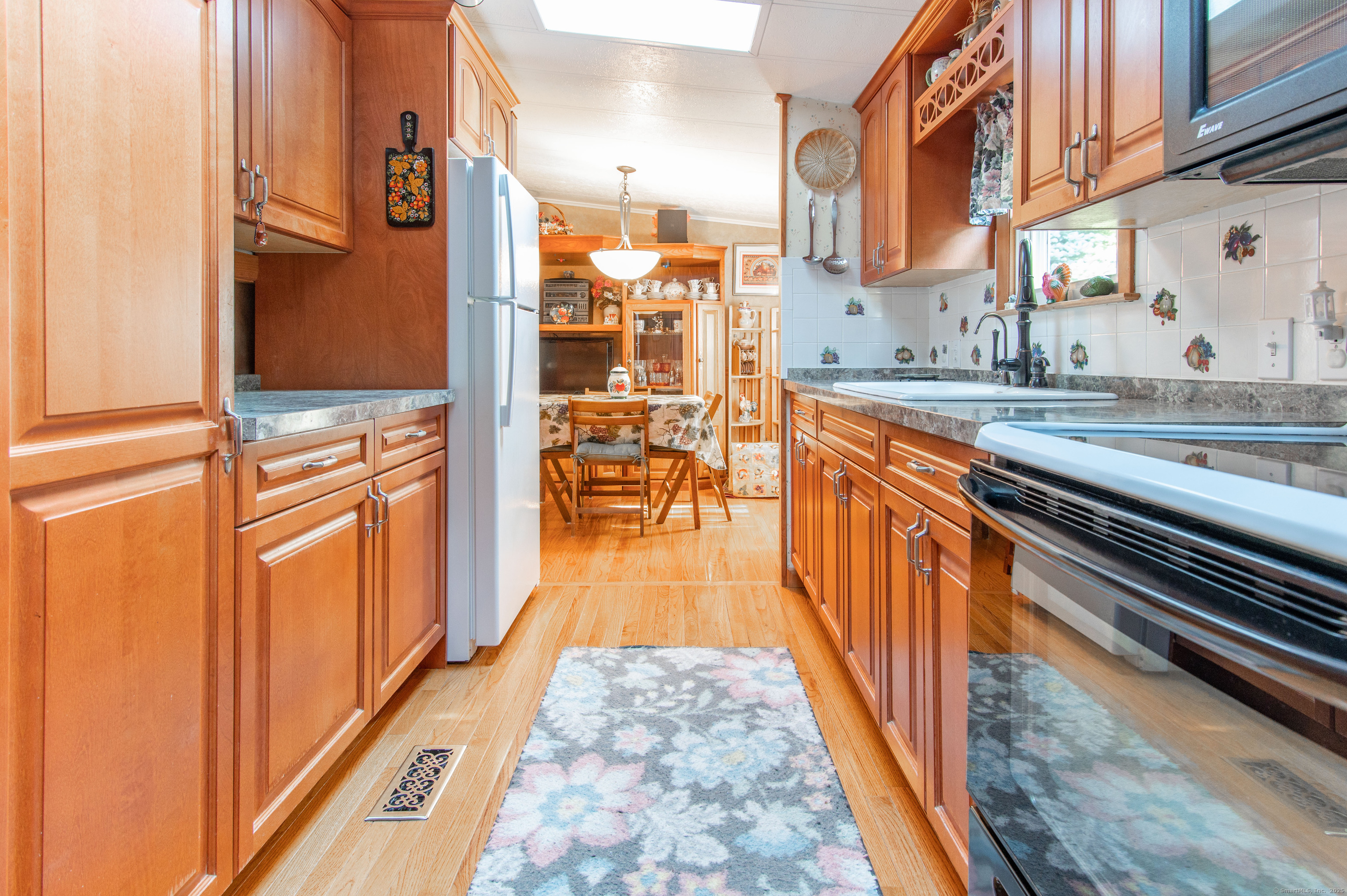26 Crescent Park Road Westport, CT 06880 - Photo 4 of 23 a view of a kitchen with stainless steel appliances granite countertop a refrigerator and a stove top oven