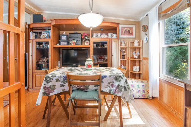 a view of a dining room with furniture window and wooden floor