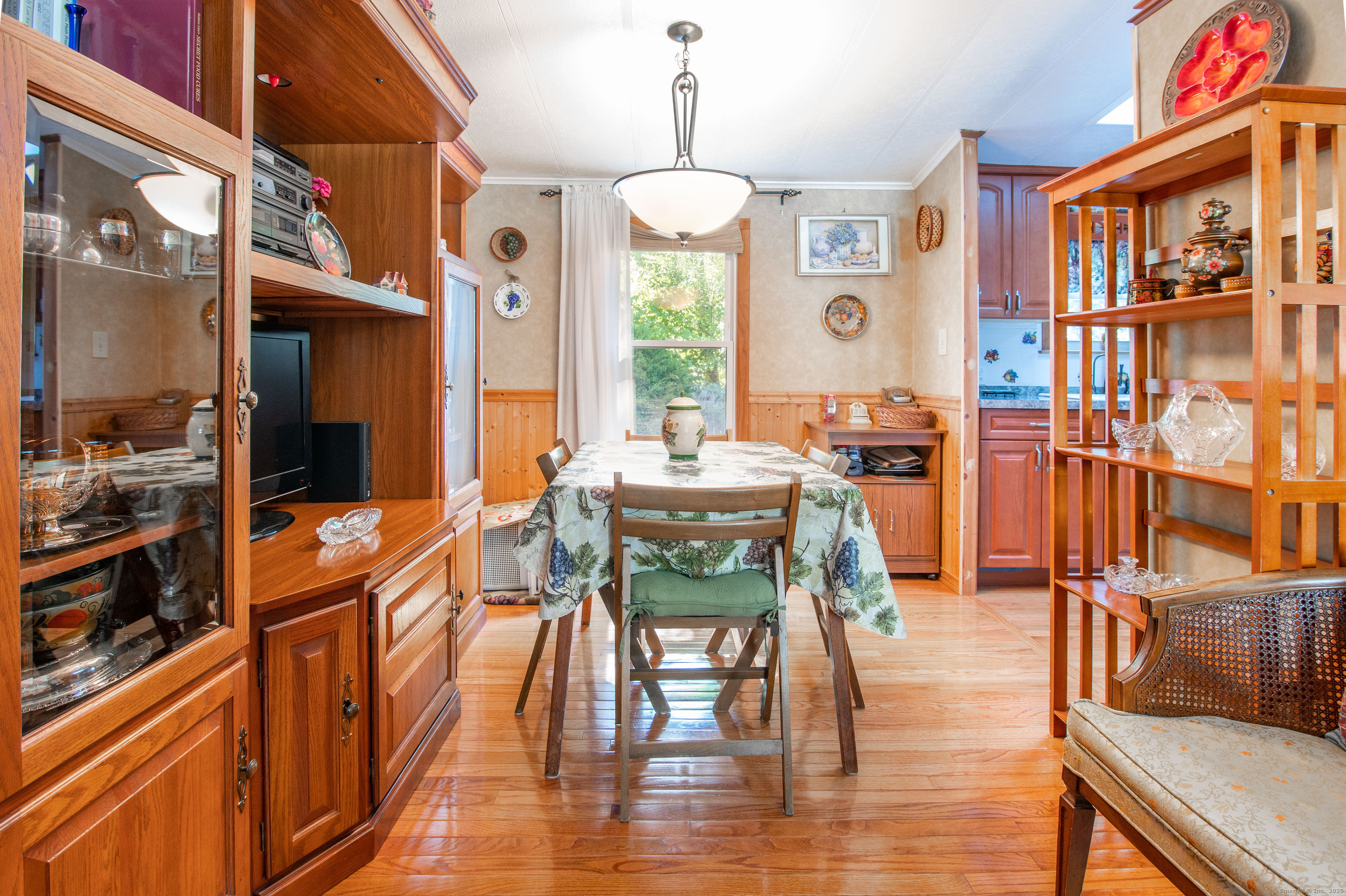 26 Crescent Park Road Westport, CT 06880 - Photo 7 of 23 a dining room with furniture a chandelier and wooden floor