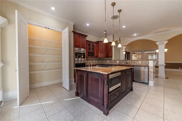 a view of staircase with lots of frames on wall and wooden floor