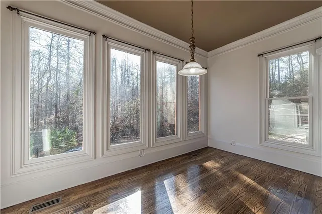 a view of staircase with railing and white walls