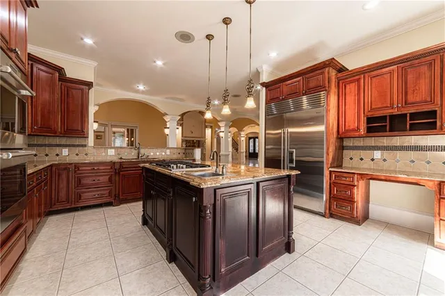 a view of a big room with windows and chandelier fan