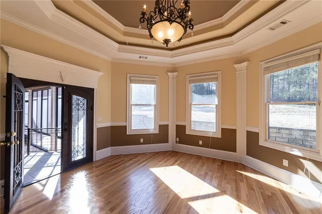 a view of a room with window and ceiling fan