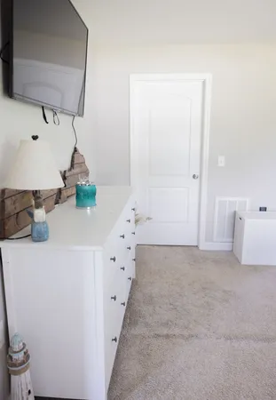 a bathroom with a sink a toilet a window and shower