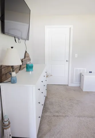 a bathroom with a sink a toilet a window and shower