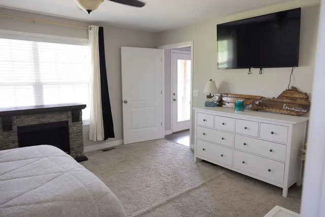 a bathroom with a granite countertop sink a toilet and a mirror