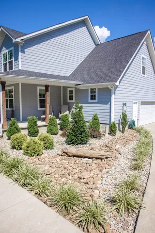 a view of backyard of house with green space