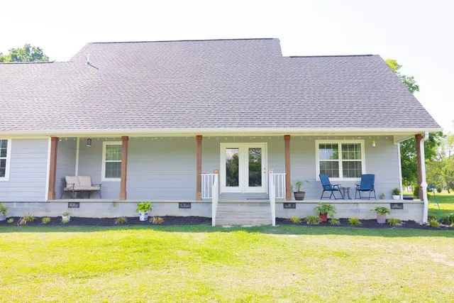 a view of a house with swimming pool and sitting area