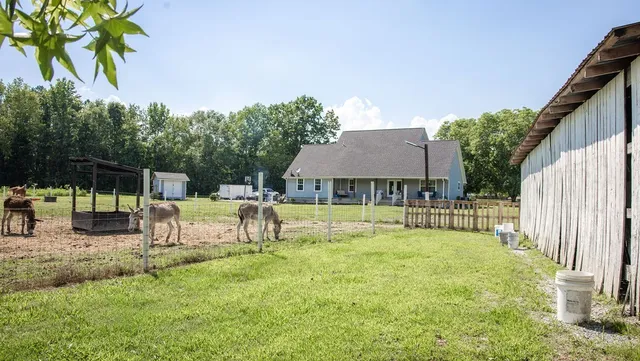 a view of a porch with a table and chairs