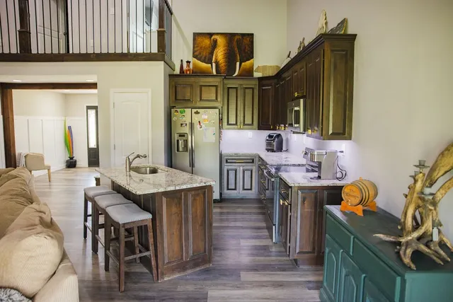 a kitchen with stainless steel appliances granite countertop a stove and a sink