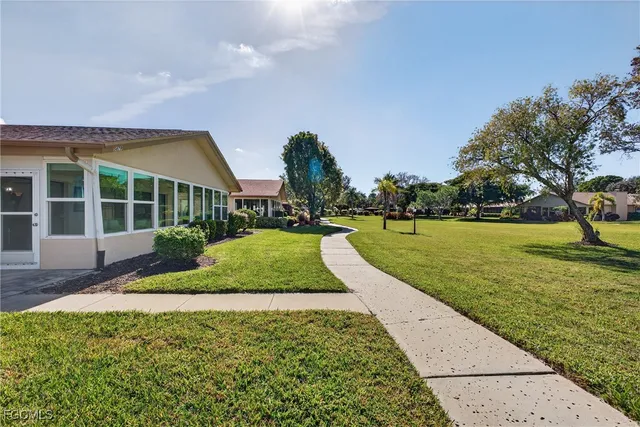 a view of yard with swimming pool and green space