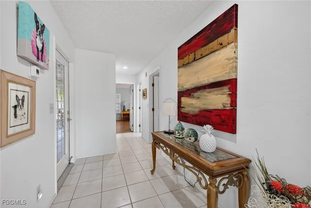 a hallway with table and chairs