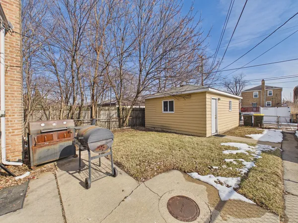 a backyard of a house with table and chairs