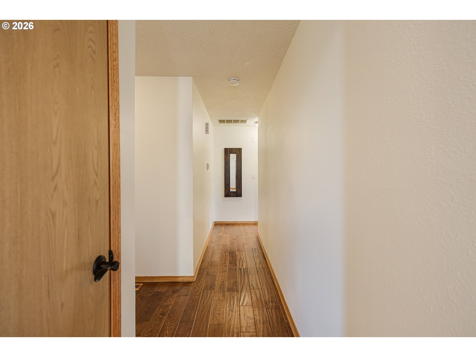 913 South Fir Court Canby, OR 97013 - Photo 17 of 37 a view of hallway with wooden floor