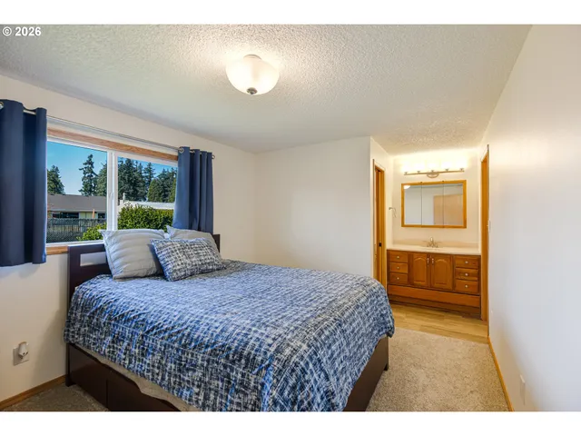 a bedroom with a large bed and a window