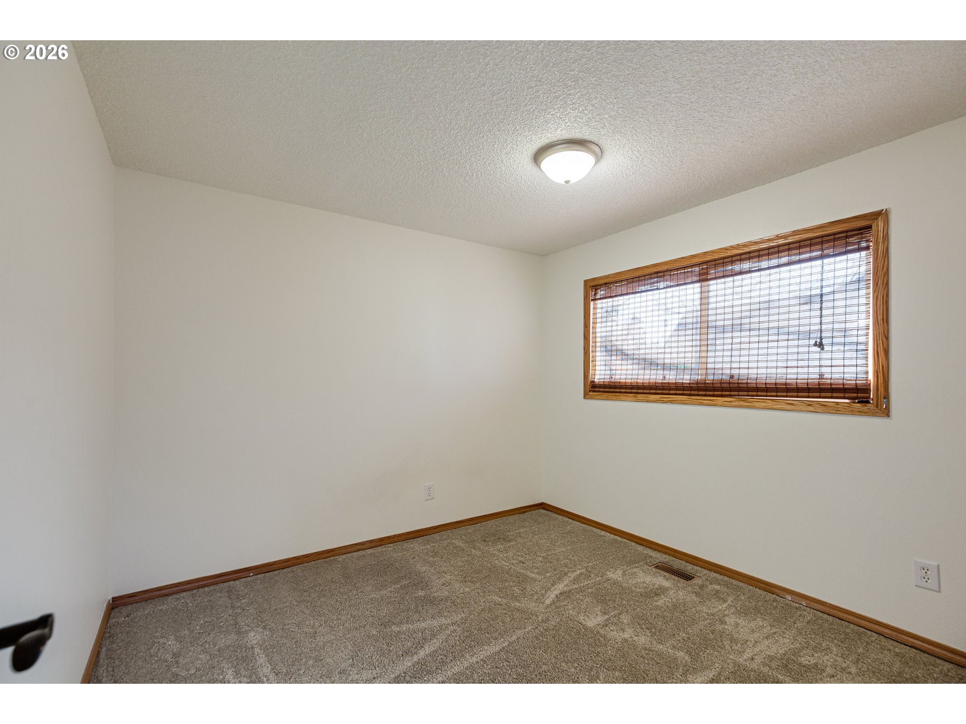 913 South Fir Court Canby, OR 97013 - Photo 23 of 37 an empty room with wooden floor and windows