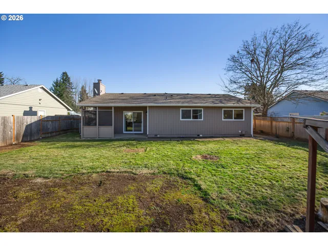 a view of a house with a backyard
