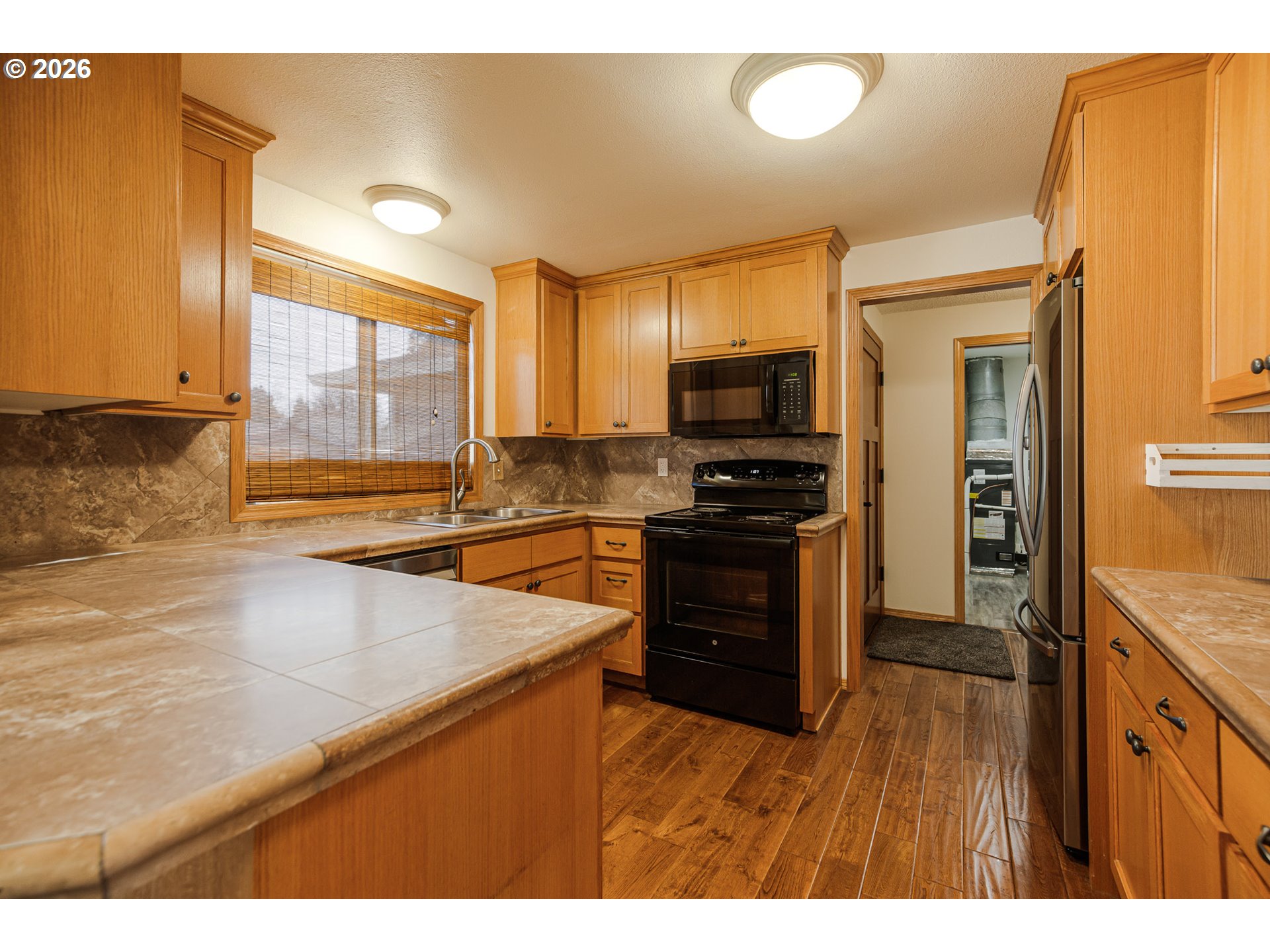 913 South Fir Court Canby, OR 97013 - Photo 4 of 37 a kitchen with stainless steel appliances a refrigerator sink and stove