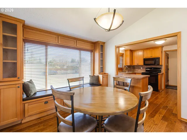 a dining room with furniture and wooden floor