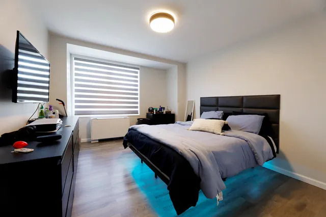 a bedroom with a bed and a window