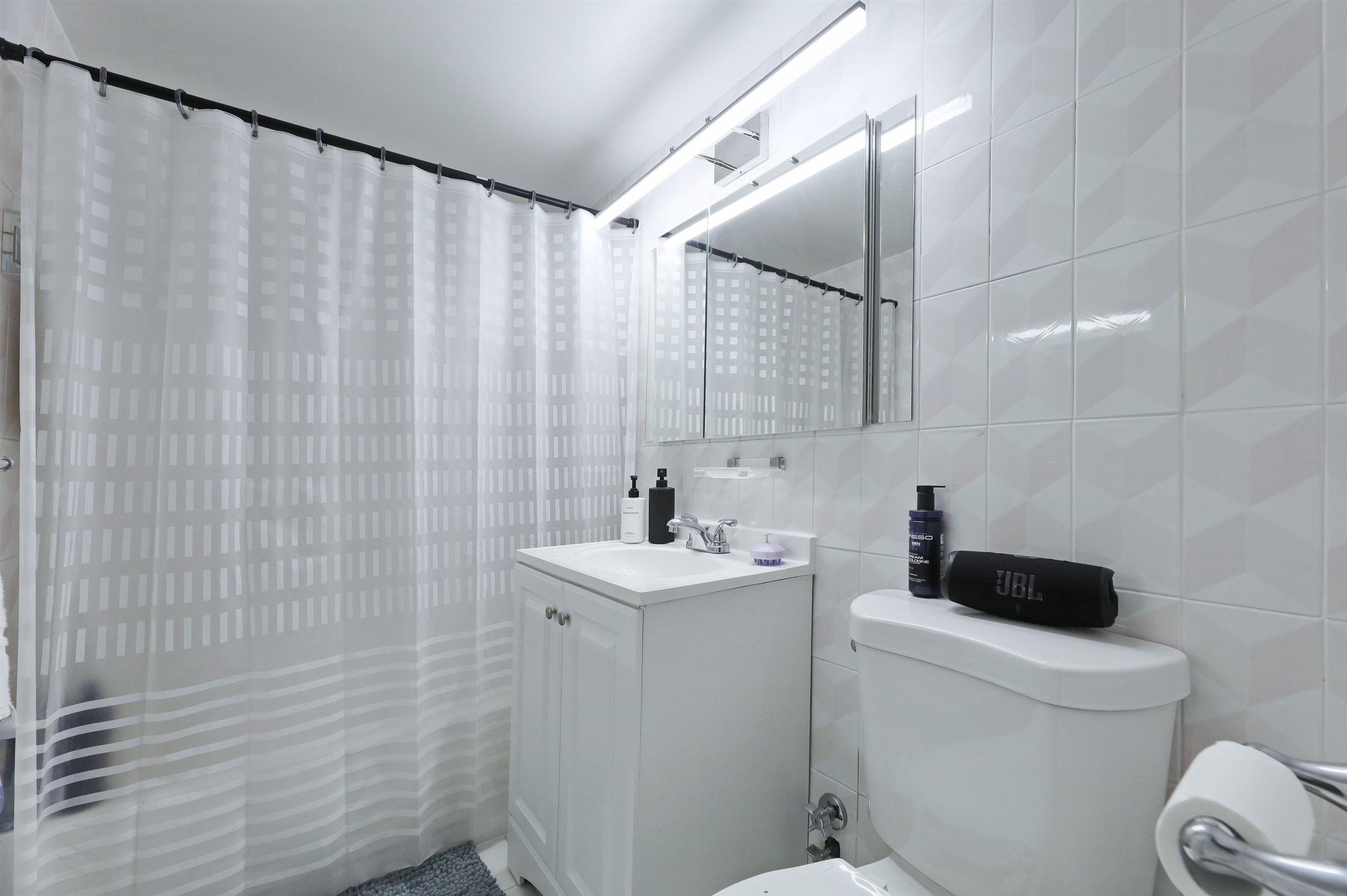 301 Beech Street, Unit 7A Hackensack, NJ 07601 - Photo 5 of 11 a bathroom with a sink toilet and shower