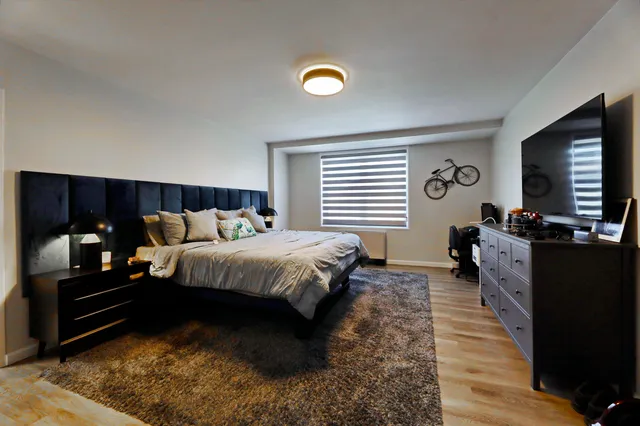 a bed room with a bed and a television