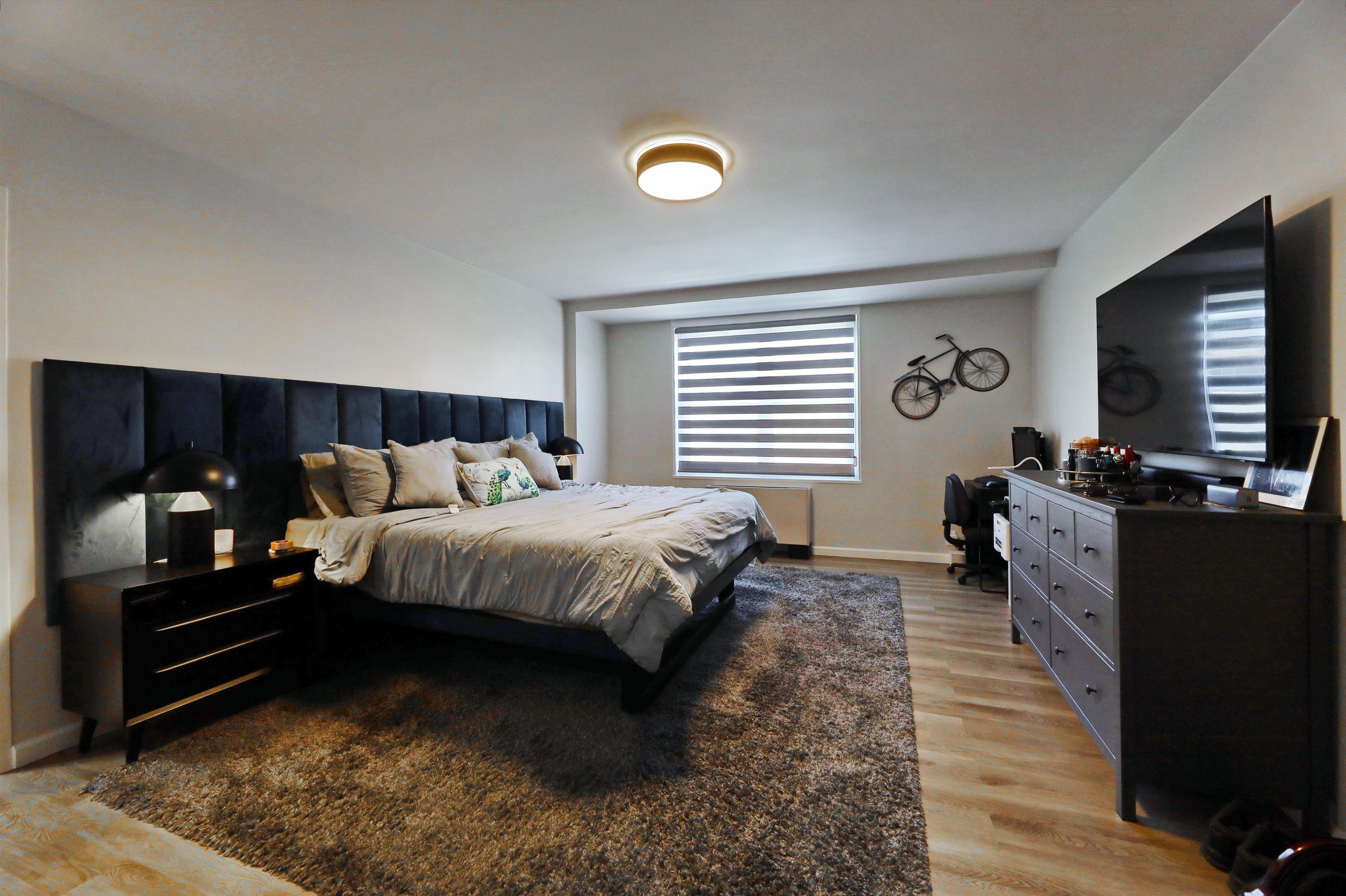 301 Beech Street, Unit 7A Hackensack, NJ 07601 - Photo 6 of 11 a bed room with a bed and a television