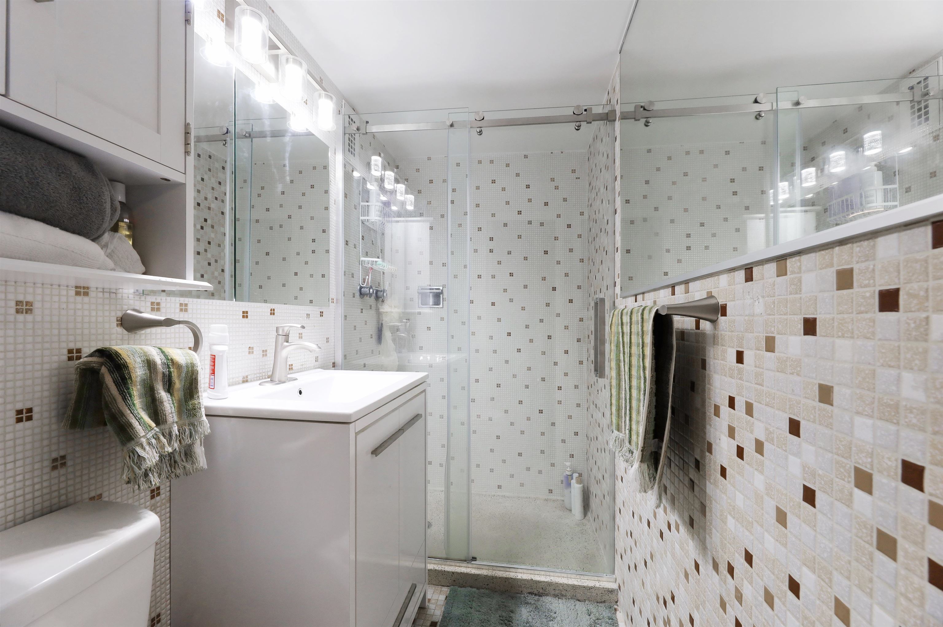 301 Beech Street, Unit 7A Hackensack, NJ 07601 - Photo 7 of 11 a bathroom with a sink a toilet and shower