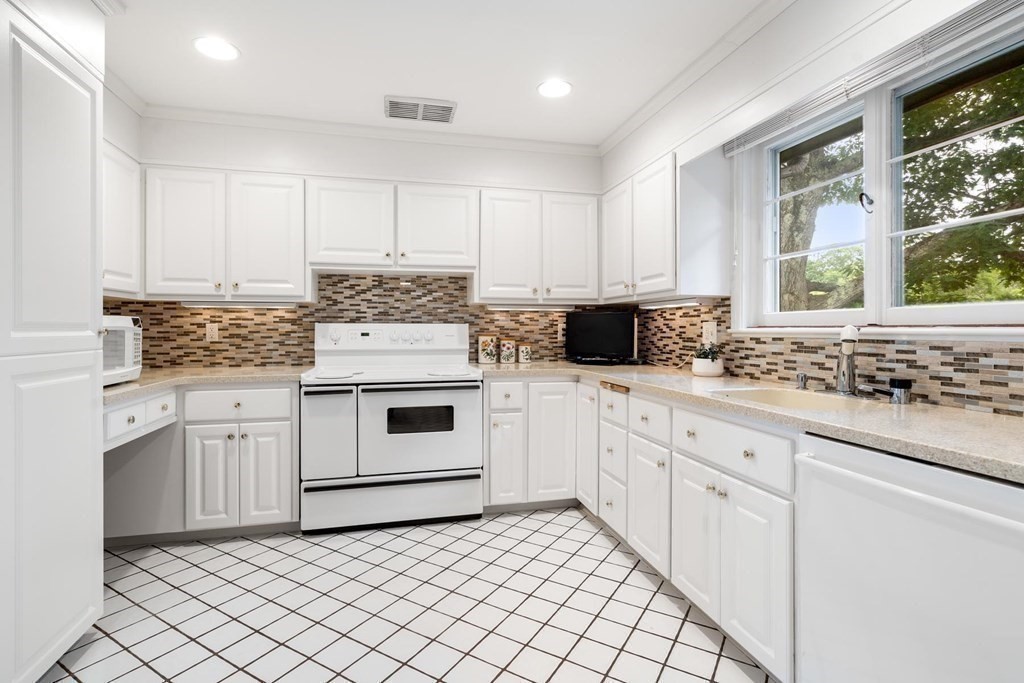 30 Burdean Road Newton, MA 02459 - Photo 12 of 29 a kitchen with granite countertop white cabinets and white stainless steel appliances