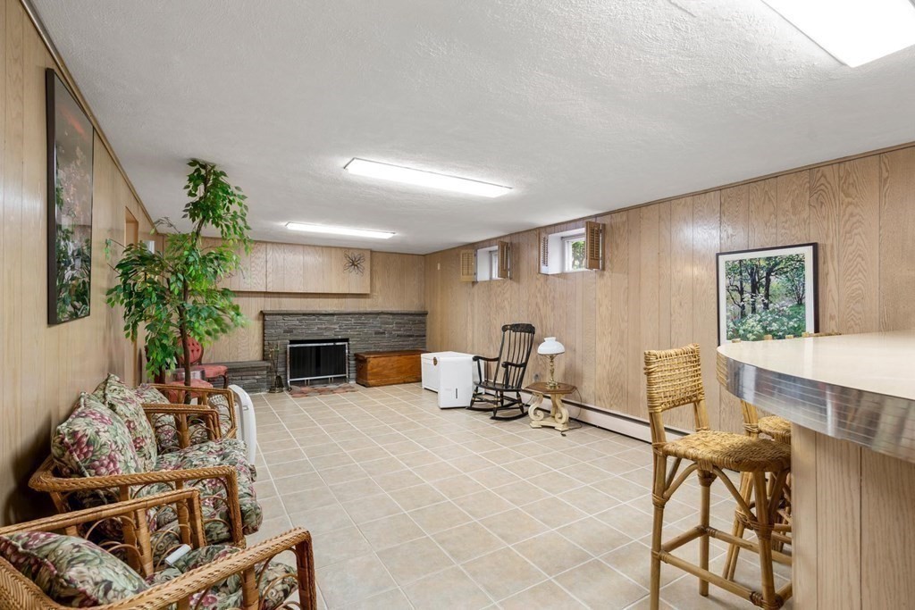 30 Burdean Road Newton, MA 02459 - Photo 22 of 29 a living room with furniture a fireplace and a potted plant