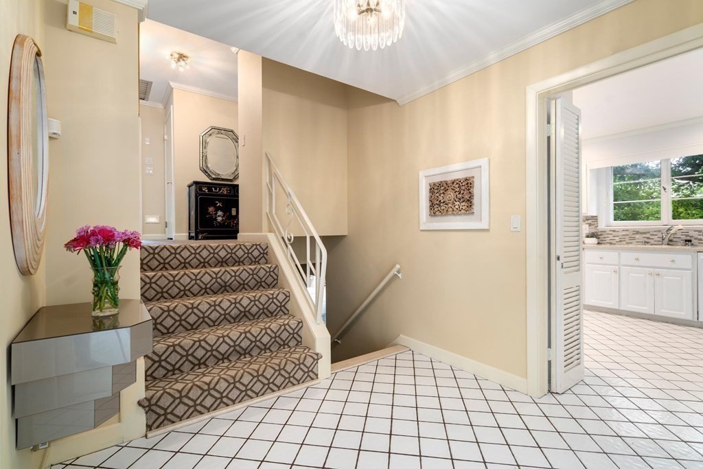 30 Burdean Road Newton, MA 02459 - Photo 5 of 29 a view of a hallway to a livingroom with furniture and a floor to ceiling window