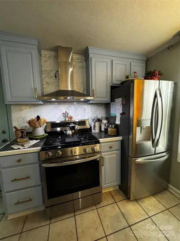 a kitchen with a sink a stove and cabinets