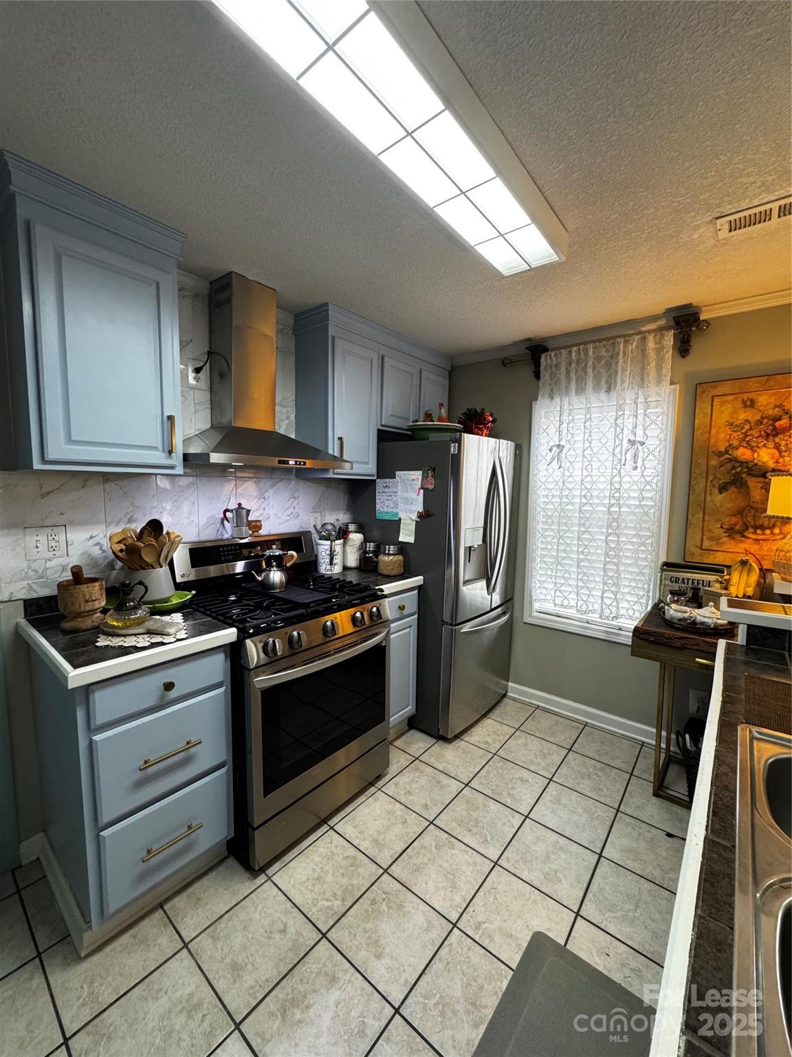 404 Moss Springs Road Albemarle, NC 28001 - Photo 16 of 33 a kitchen with a stove a refrigerator and a stove