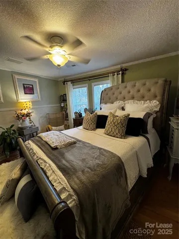 a bedroom with furniture and wooden floor