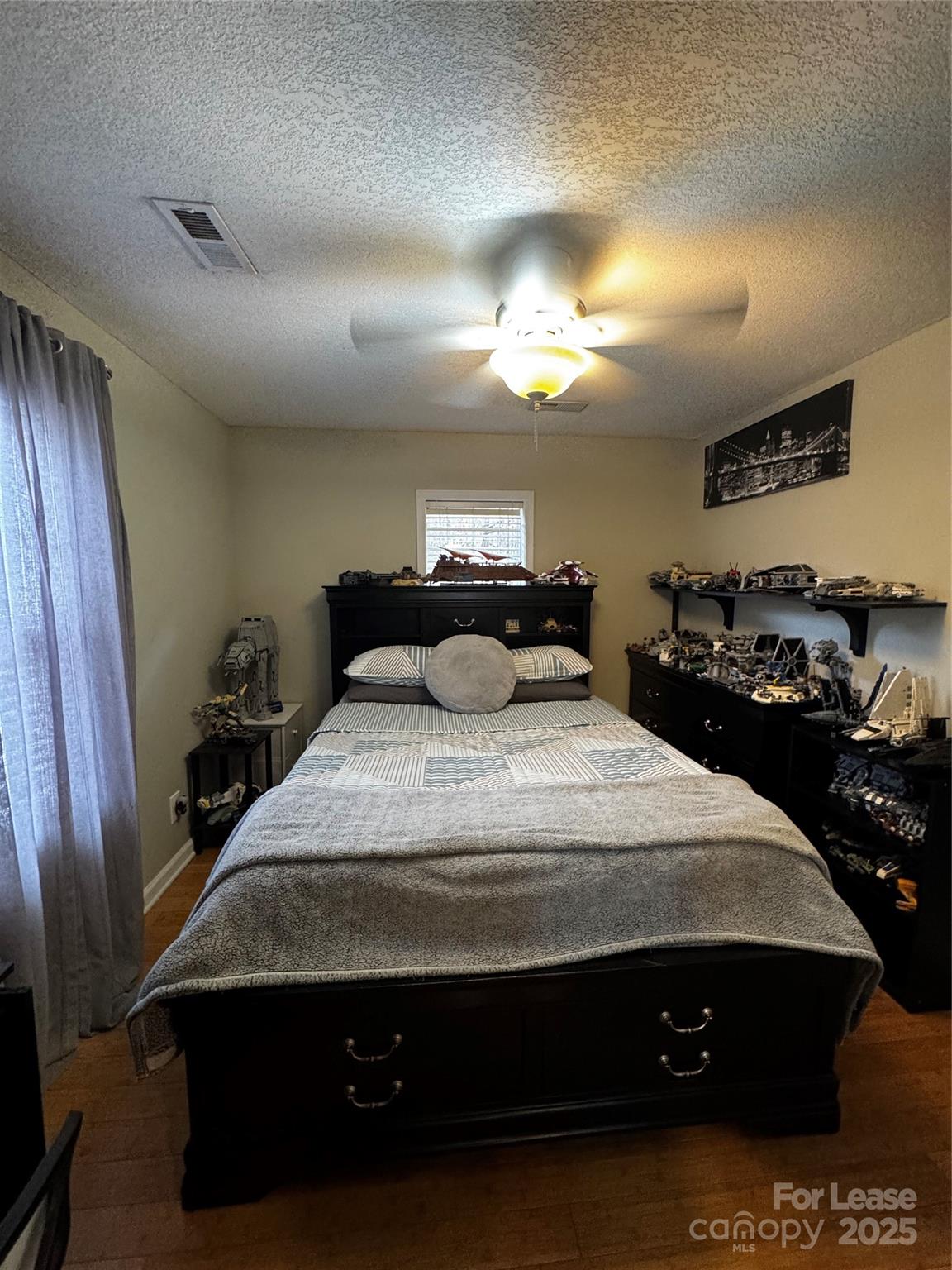 404 Moss Springs Road Albemarle, NC 28001 - Photo 19 of 33 a bedroom with a bed and a chandelier