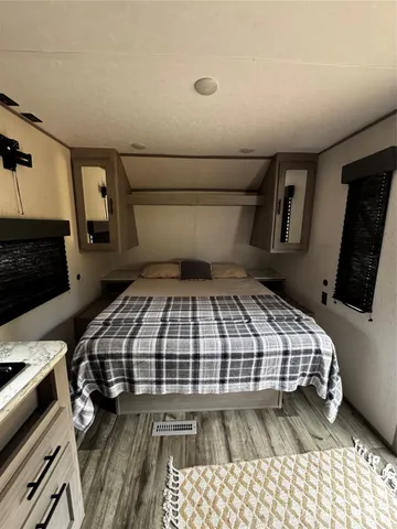 a bedroom with a bed and a mirror