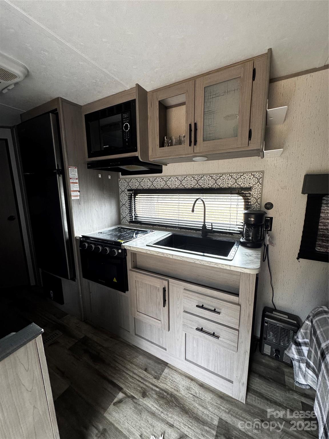 404 Moss Springs Road Albemarle, NC 28001 - Photo 29 of 33 a kitchen with granite countertop a stove microwave and sink