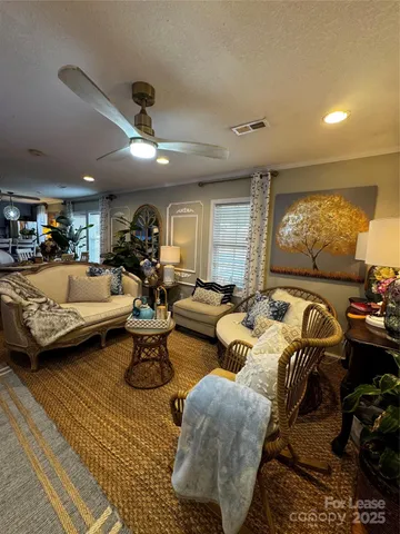 a kitchen with stainless steel appliances granite countertop a stove a sink dishwasher a dining table and chairs with wooden floor