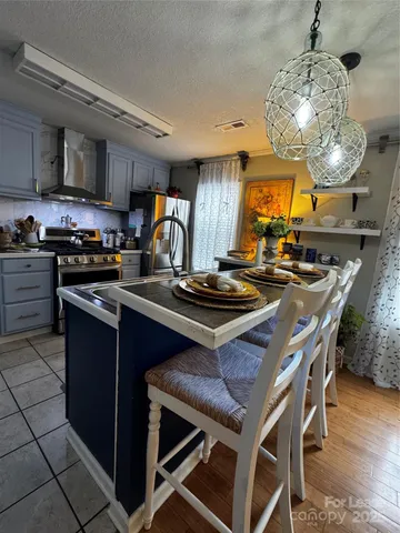 a room with lots of appliances and wooden floor