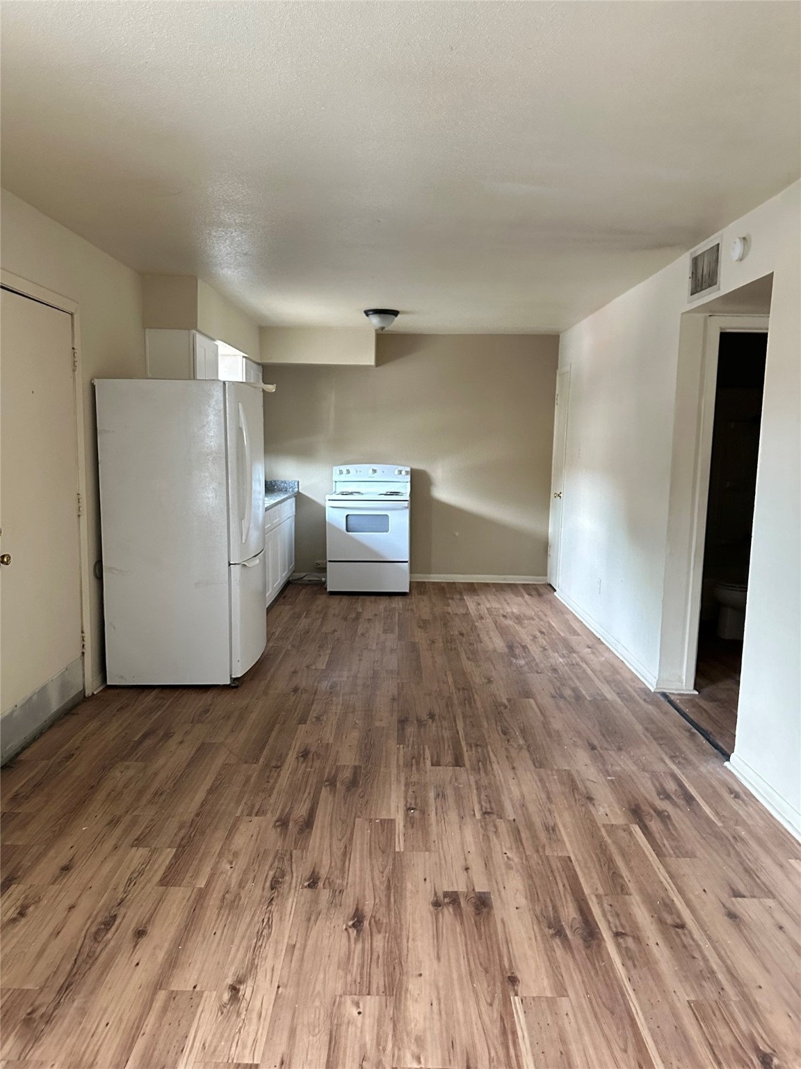 201 Sands Street, Unit 19 Angleton, TX 77515 - Photo 5 of 6 a view of empty room with wooden floor