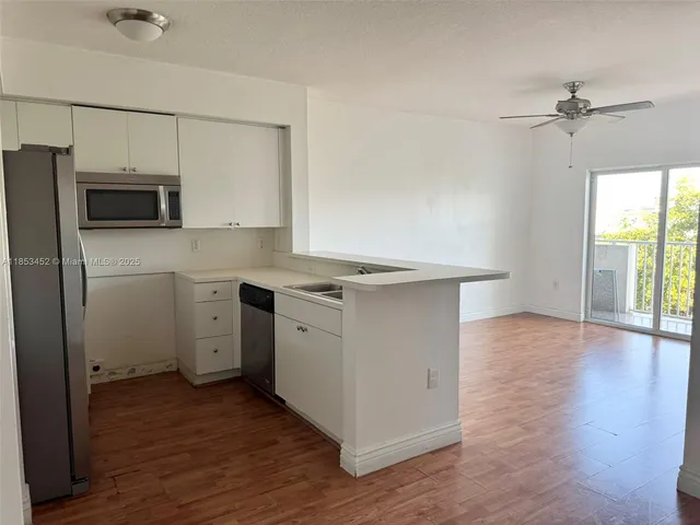 a room with a stove a sink and a refrigerator