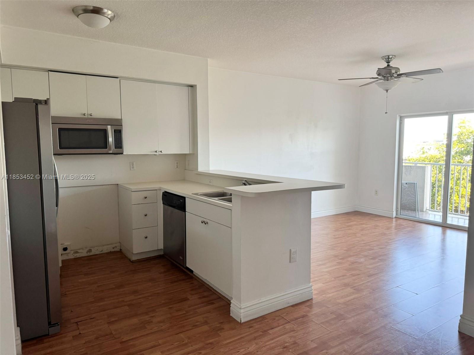 a room with a stove a sink and a refrigerator
