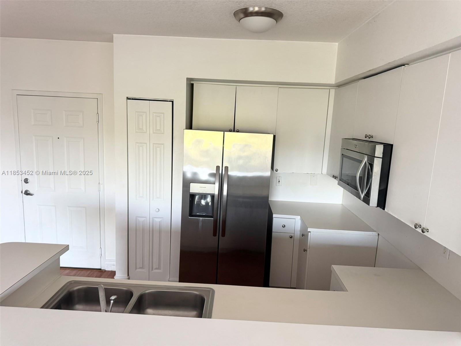 11060 Southwest 196th Street, Unit 512 Cutler Bay, FL 33157 - Photo 11 of 19 a kitchen with stainless steel appliances a refrigerator and a sink