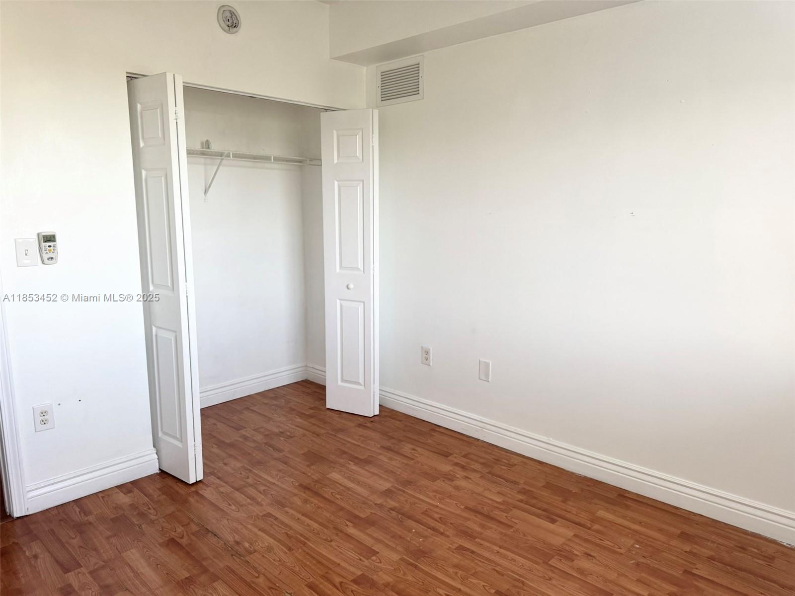 11060 Southwest 196th Street, Unit 512 Cutler Bay, FL 33157 - Photo 14 of 19 an empty room with wooden floor & closet