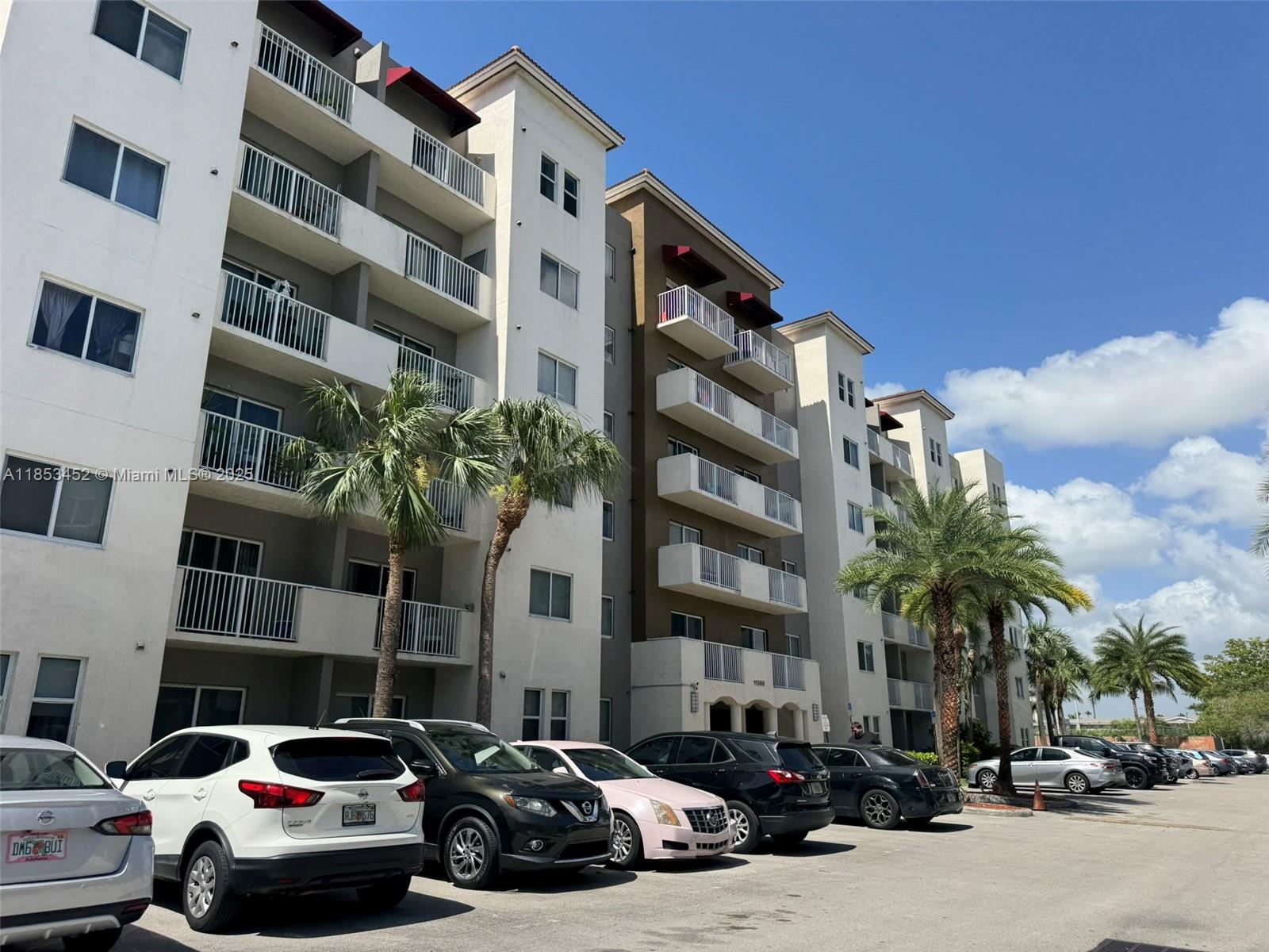 11060 Southwest 196th Street, Unit 512 Cutler Bay, FL 33157 - Photo 19 of 19 a couple of cars parked in front of a building