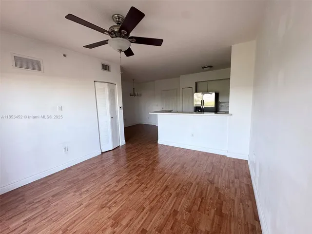 a view of empty room with wooden floor
