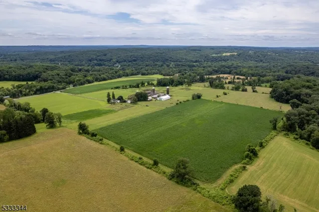 an aerial view of residential houses with outdoor space and river