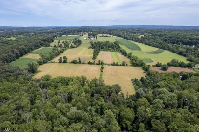 an aerial view of ocean with residential house and outdoor space