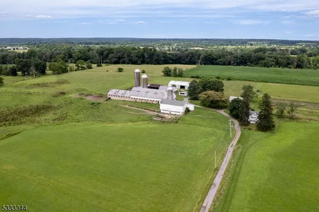 a view of a lake with a yard and outdoor seating